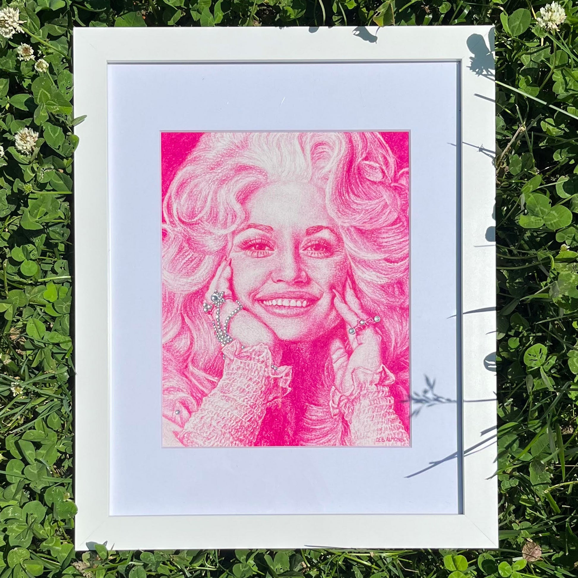 Portrait of Dolly Parton in vibrant pink pencil pastel with rhinestone embellishment.